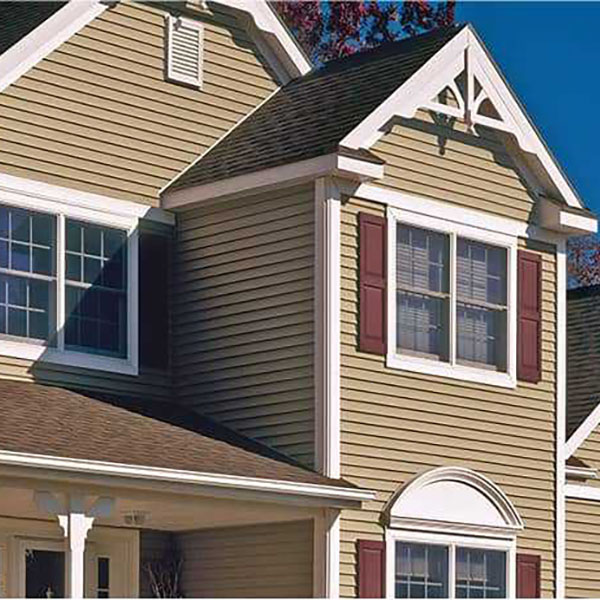 Close-up of residential home with beige vinyl siding by CertainTeed