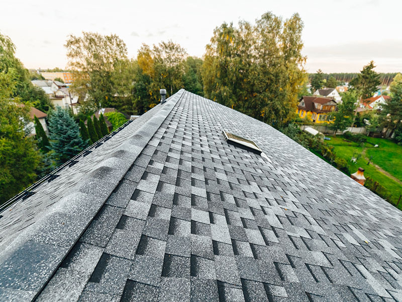 Close-up of a residential roof with brand new gray shingles installed